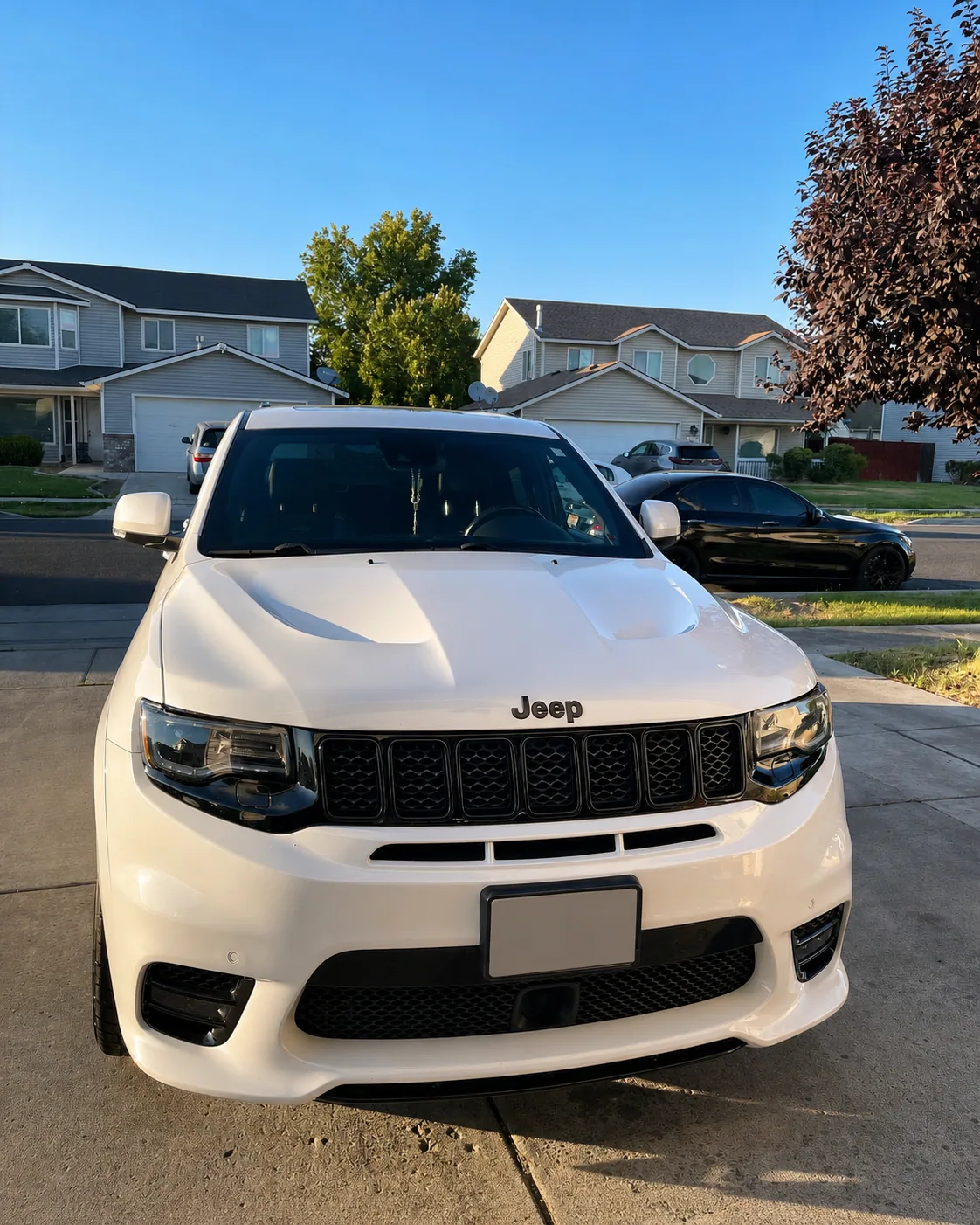 Finished white Jeep photographed after detailing with its license plate obscured for privacy